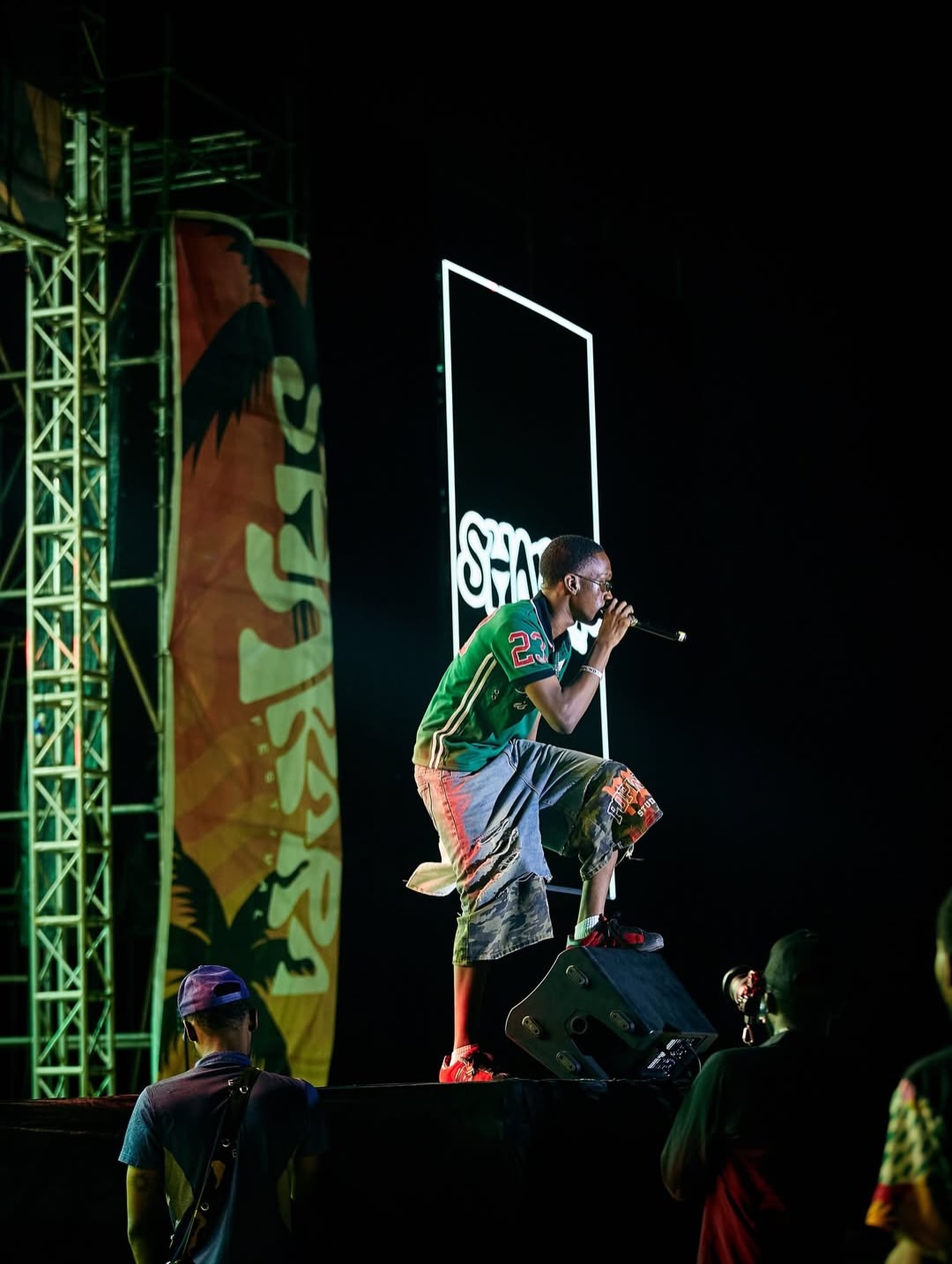 Artist performing beside Shakara Festival branding
