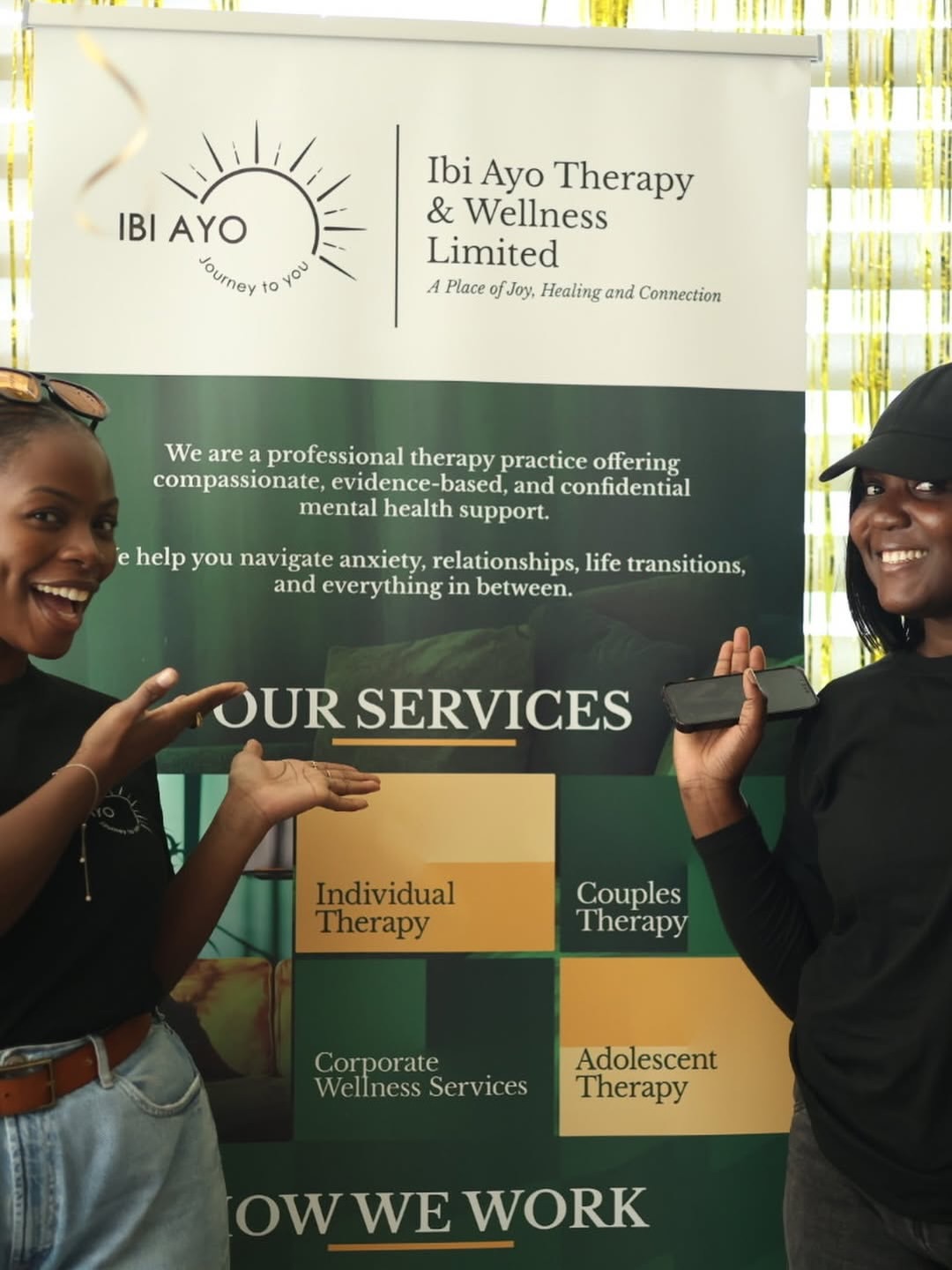 Guests beside the Ibi Ayo Therapy and Wellness banner at Glow Circle